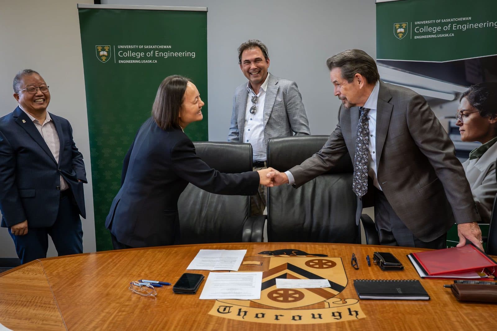 SiFusion Energy's Robert McKenzie shaking hands with the University of Saskatchewan College of Engineering research team at the collaboration signing.